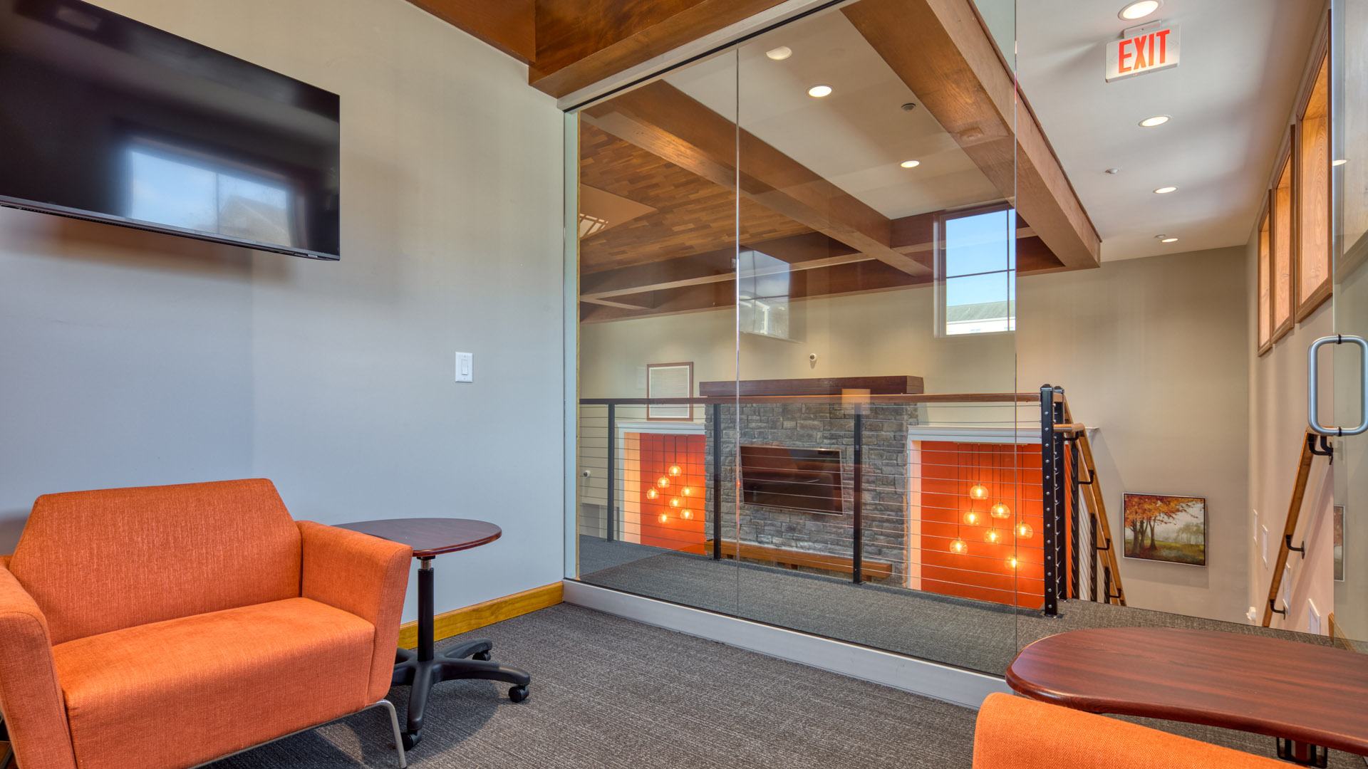 A room with a fireplace and a chair.